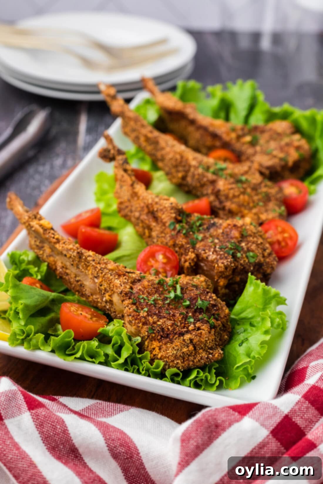 Side photo of Fried Lamb Chops resting on a bed of lettuce