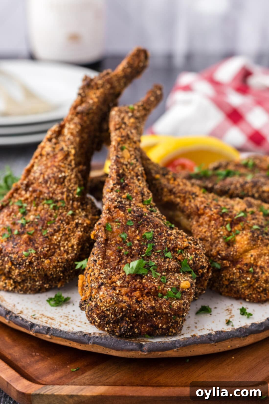 Fried Lamb Chops stacked together on a plate