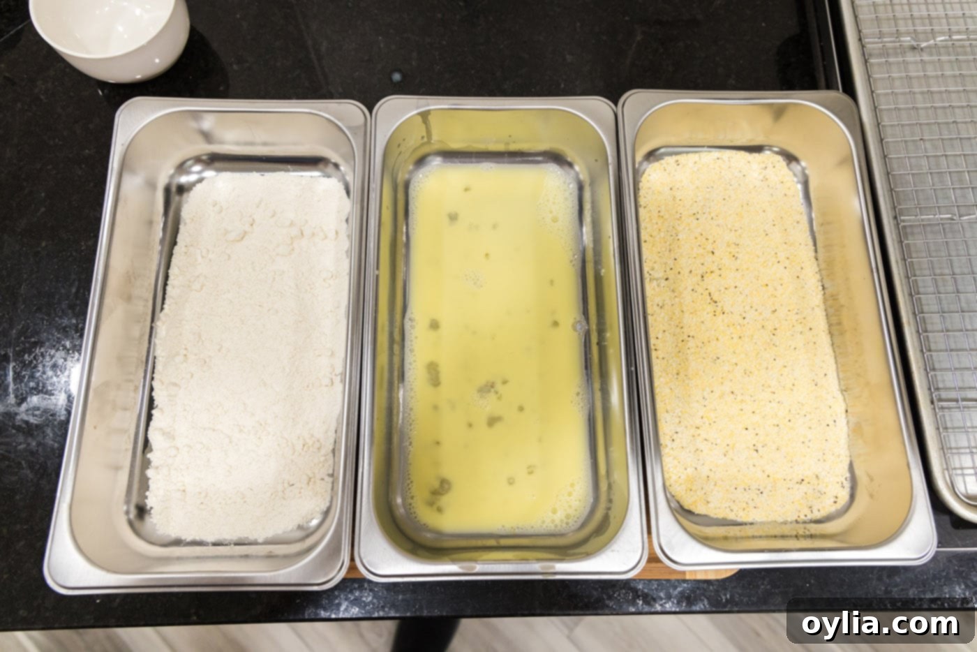dredging station with flour, egg mixture, and cornmeal mixture