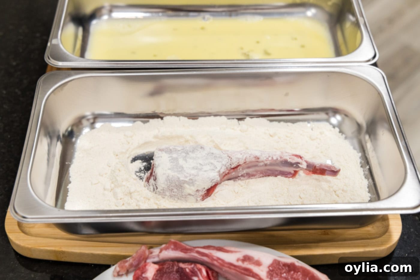 dredging lamb chop in flour