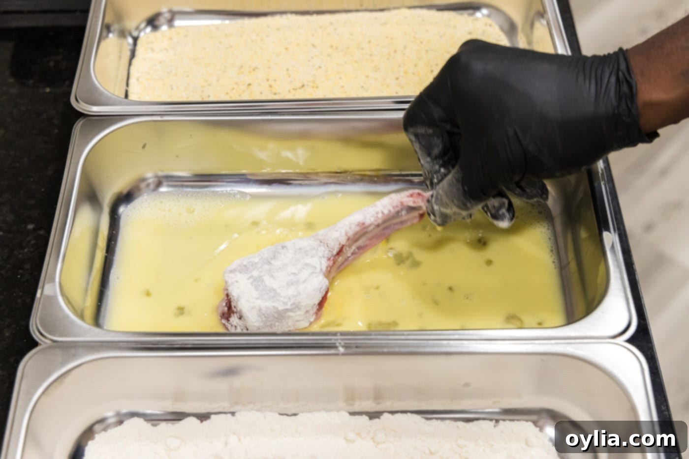 dipping lamb chop in egg mixture
