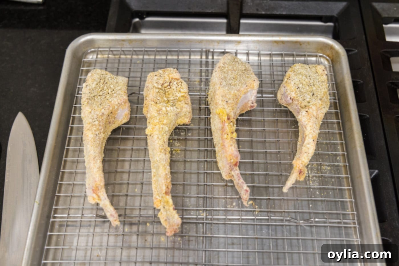 dredged lamb chops on a wire rack