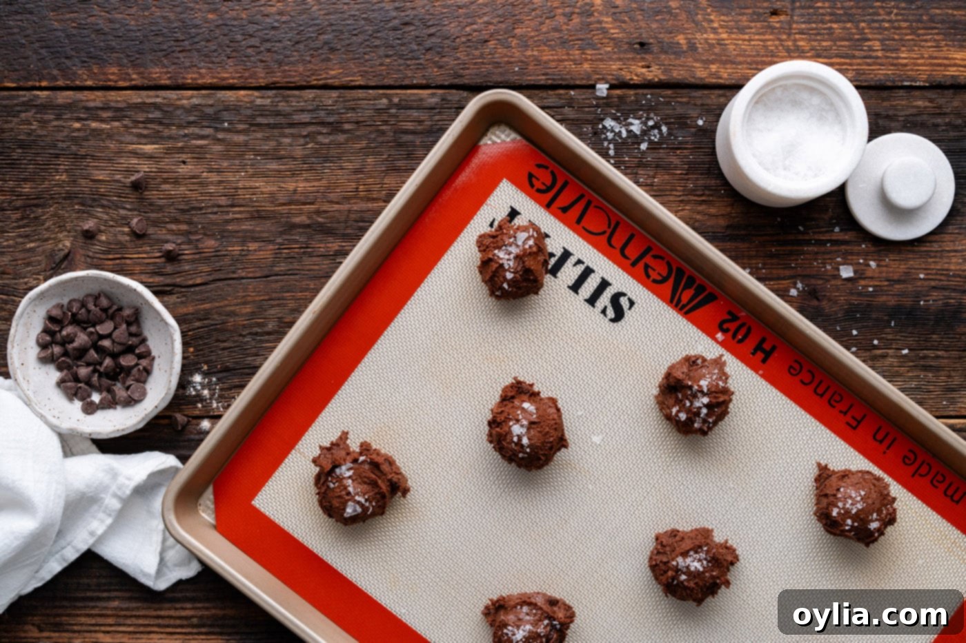 brownie cookie dough balls with flakey sea salt sprinkled on top, ready for baking