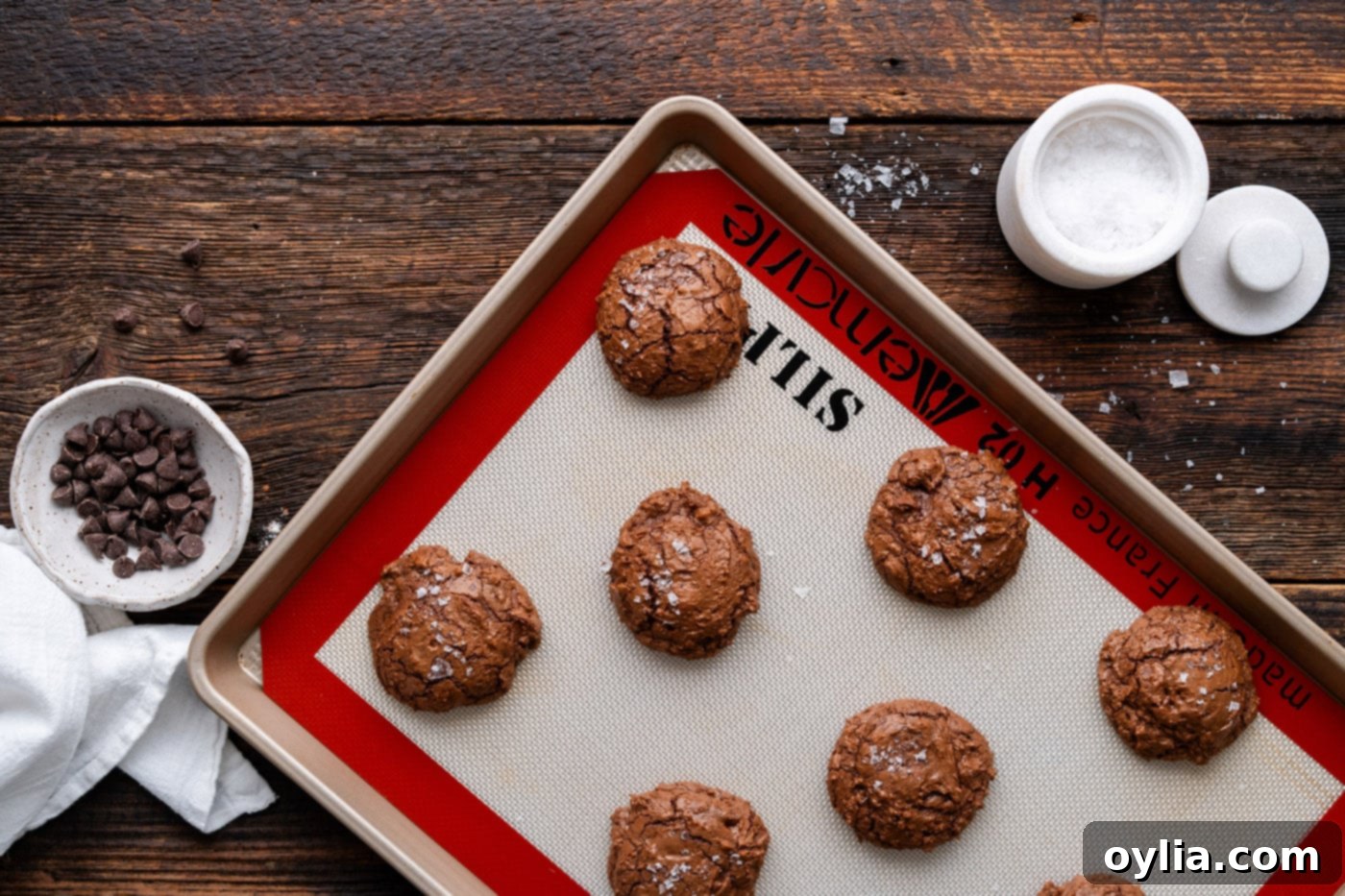salted brownie cookies on a baking sheet, fresh out of the oven