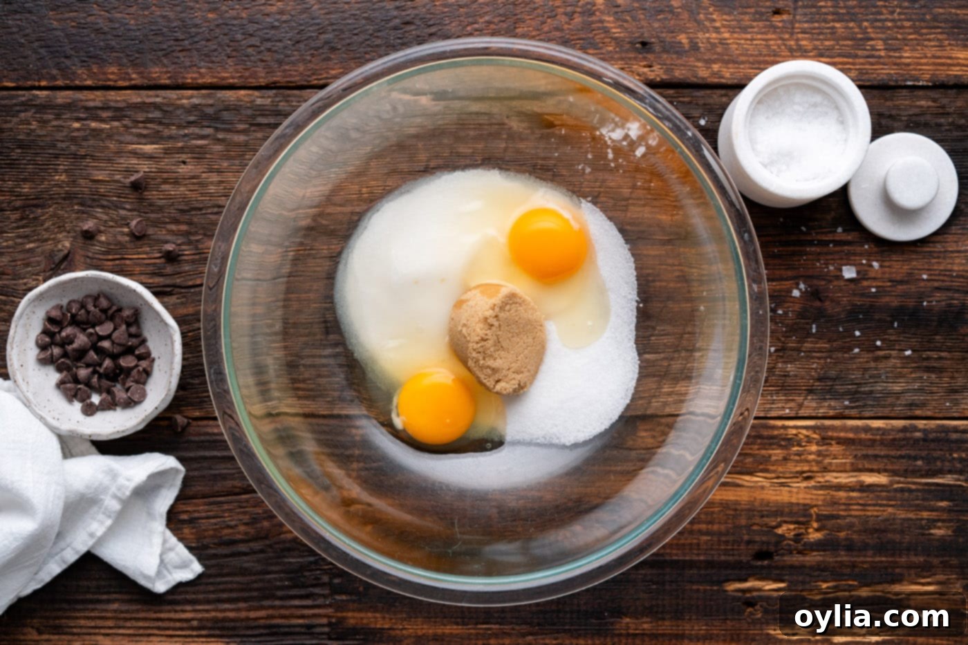 eggs with brown and white sugar in a bowl before beating