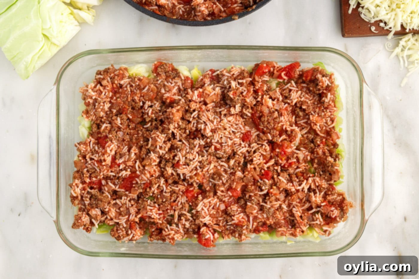 ground beef and rice mixture on top of cabbage in a dish