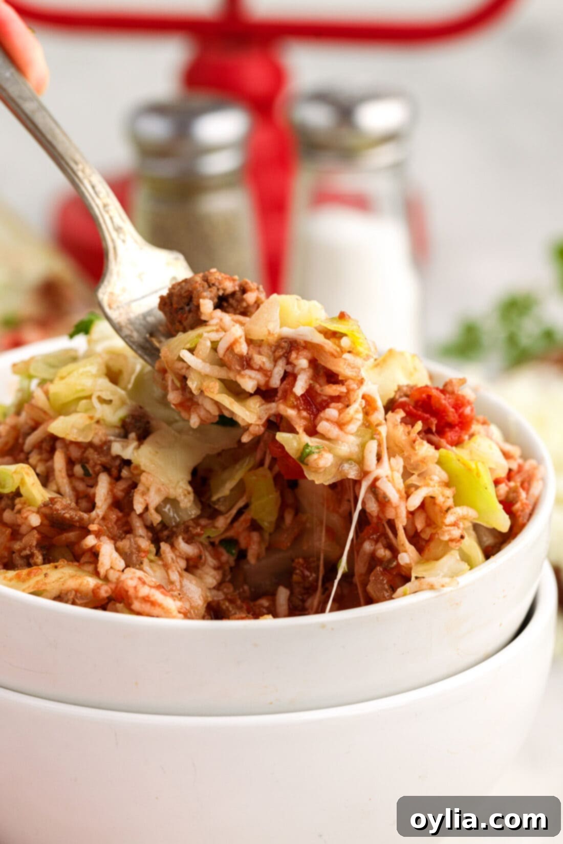 Forkull of Cabbage Roll Casserole being lifted out of a bowl of Cabbage Roll Casserole