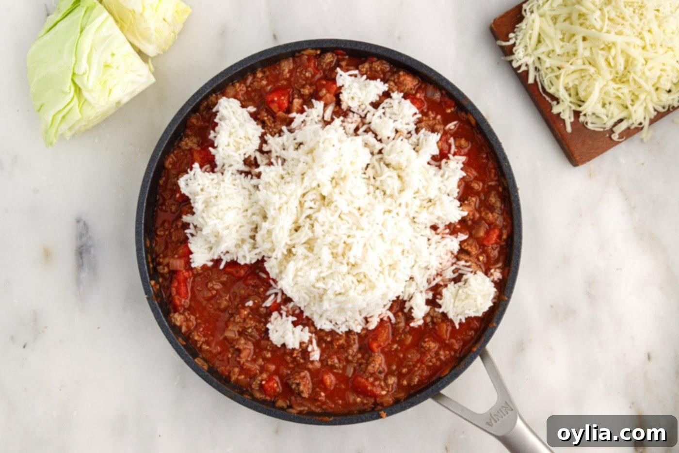 white rice added to skillet with cabbage roll filling