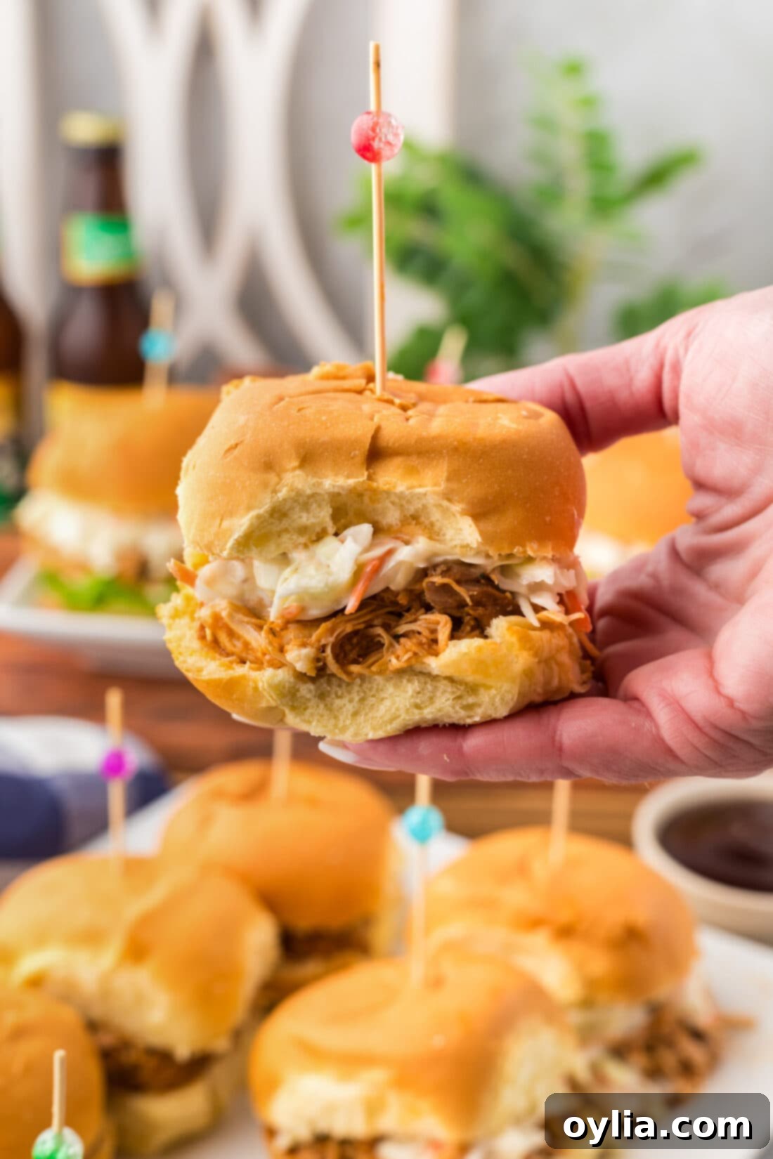 Hand holding up a BBQ Chicken Slider