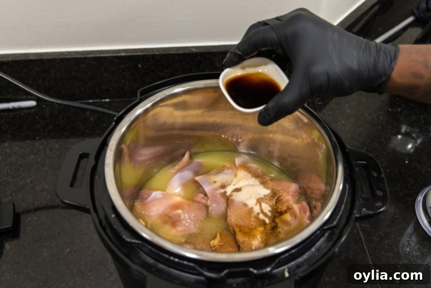 adding Worcestershire sauce to instant pot with chicken