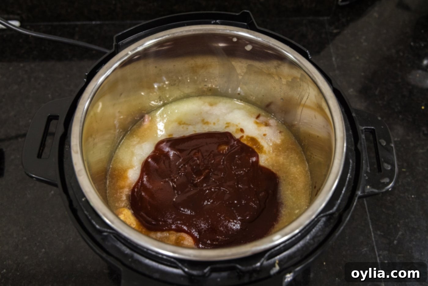 barbecue sauce on top of chicken mixture in instant pot