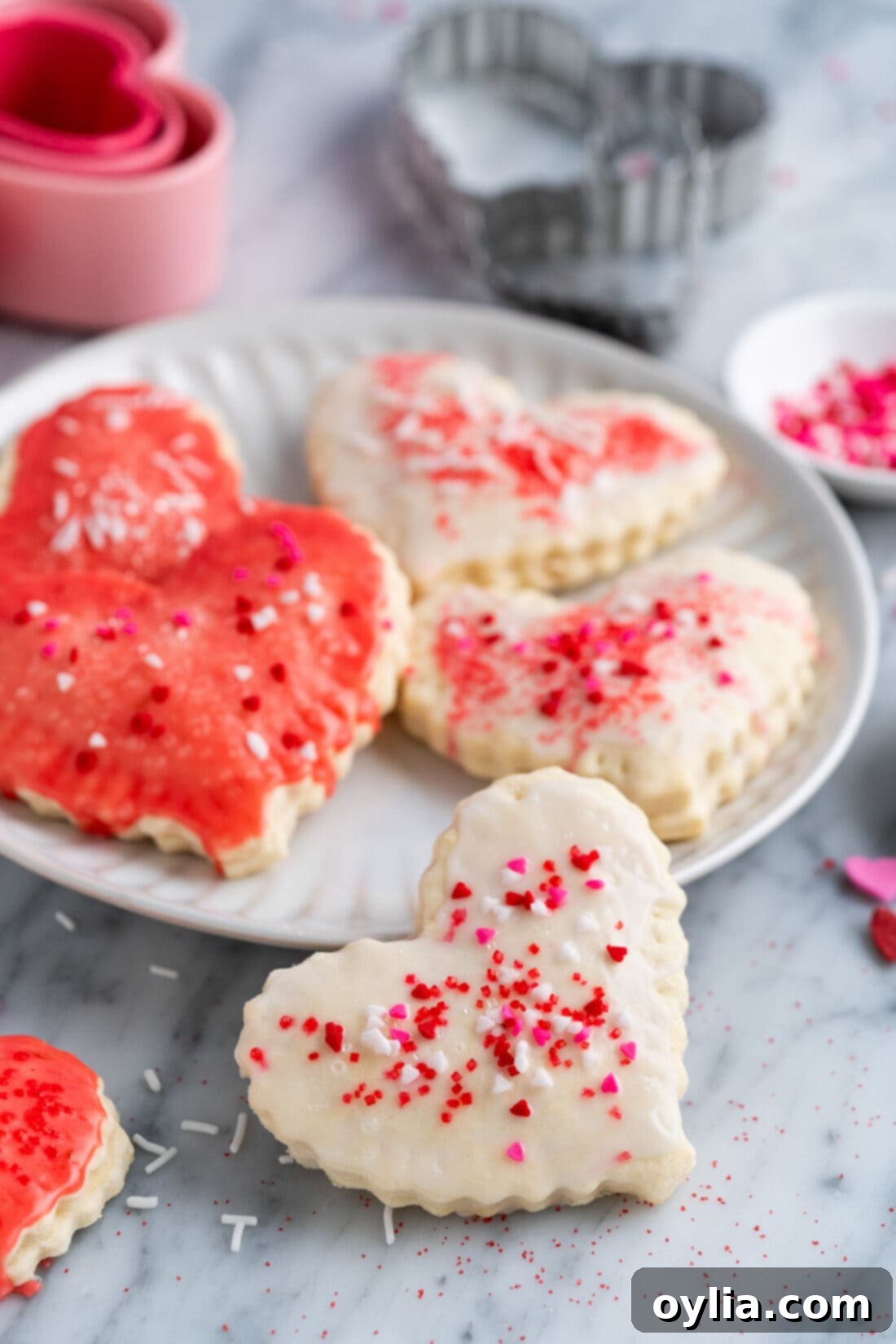 Heart Shaped Pop Tart resting on the side of a plate with more on the plate