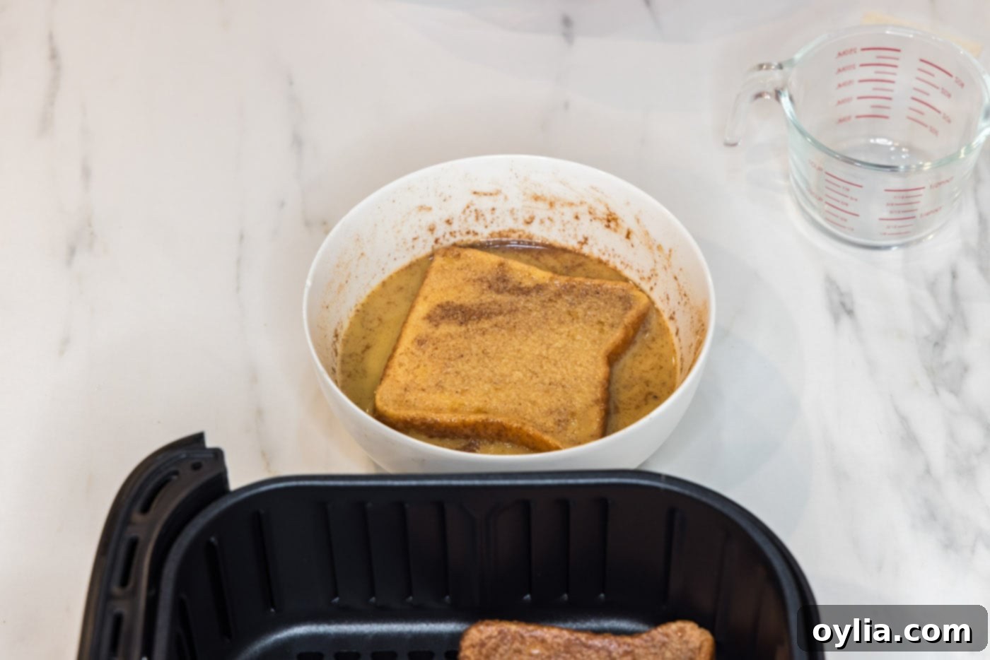 coating bread slice in egg mixture
