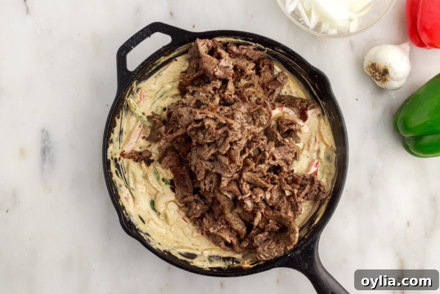 sliced flank steak added on top of cream cheese and veggie mixture