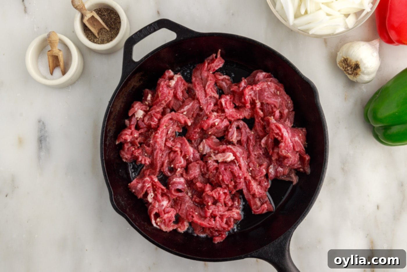 searing flank steak slices in a skllet