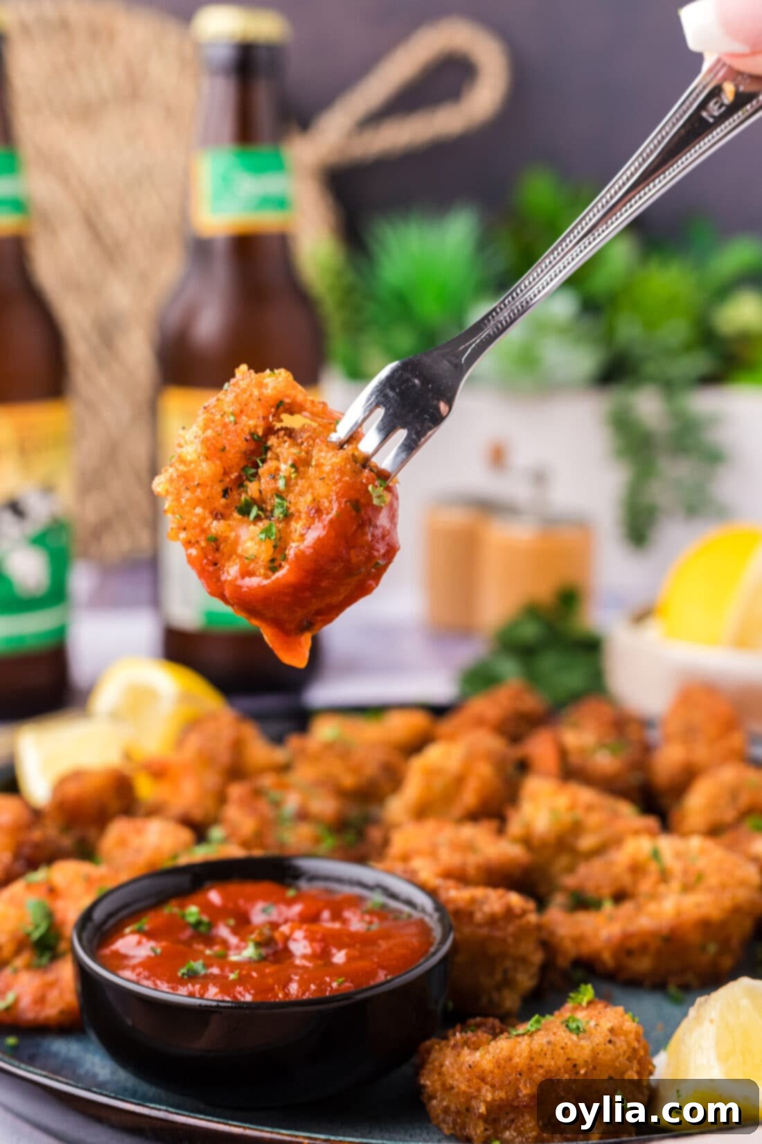 Breaded Shrimp dipped in cocktail sauce on a fork