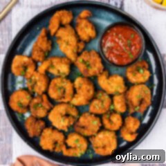 Breaded Shrimp on a plate with a bowl of cocktail sauce