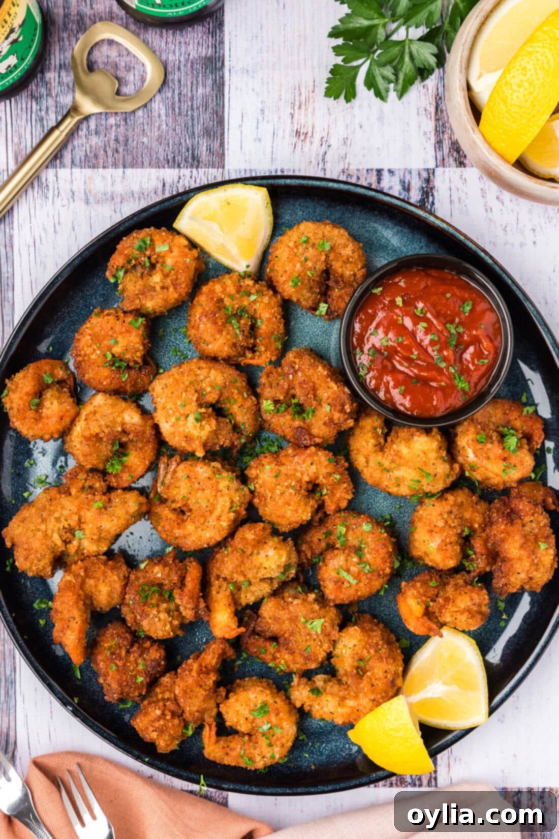 Breaded Shrimp on a plate with lemon wedges