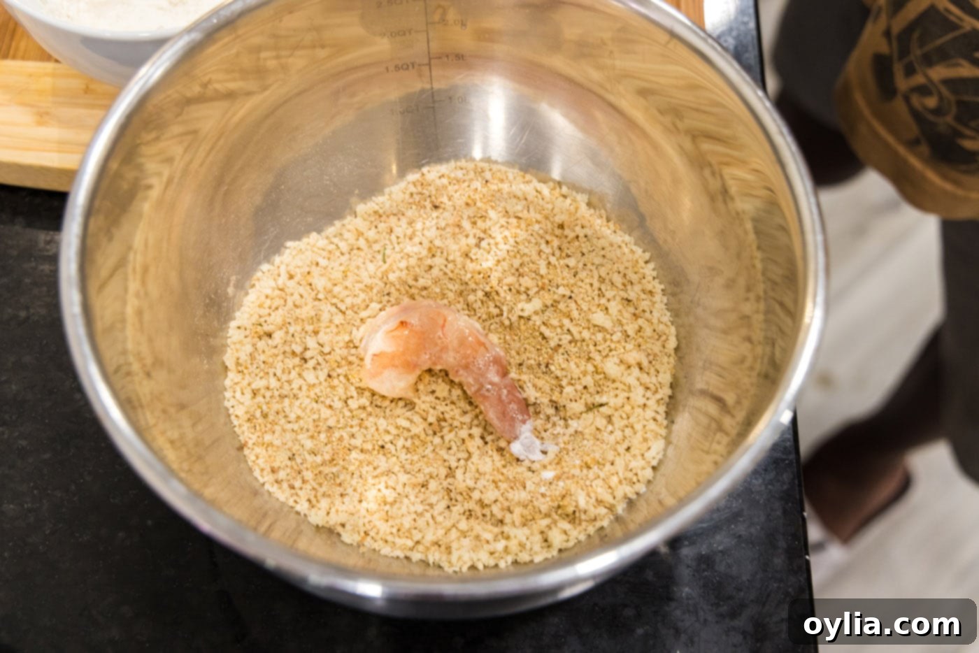 coating dredged shrimp in bread crumb mixture