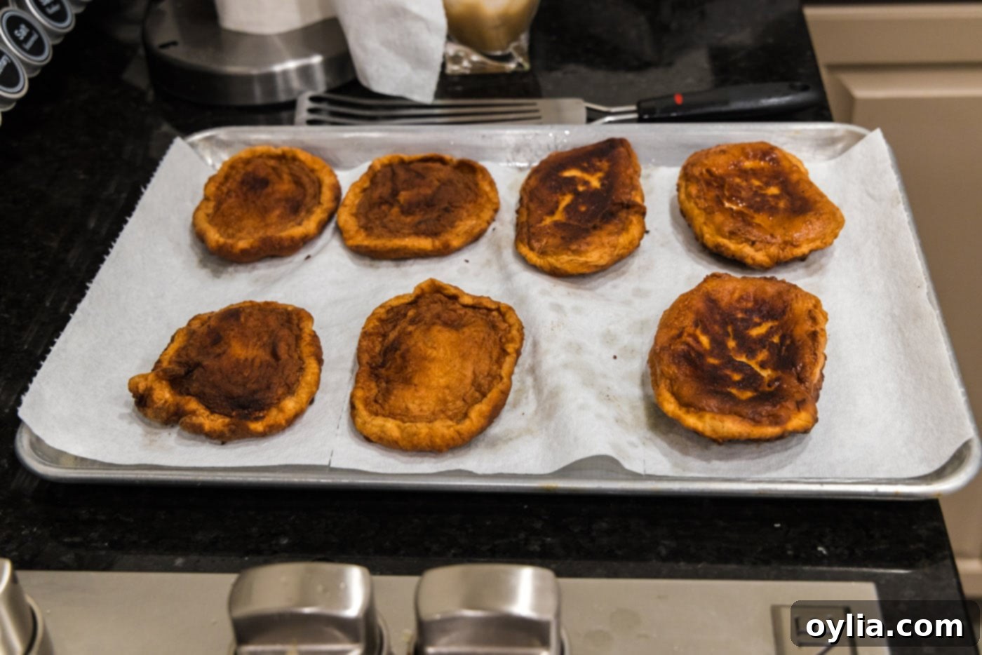 Korean fish cakes draining on a paper towel-lined baking sheet