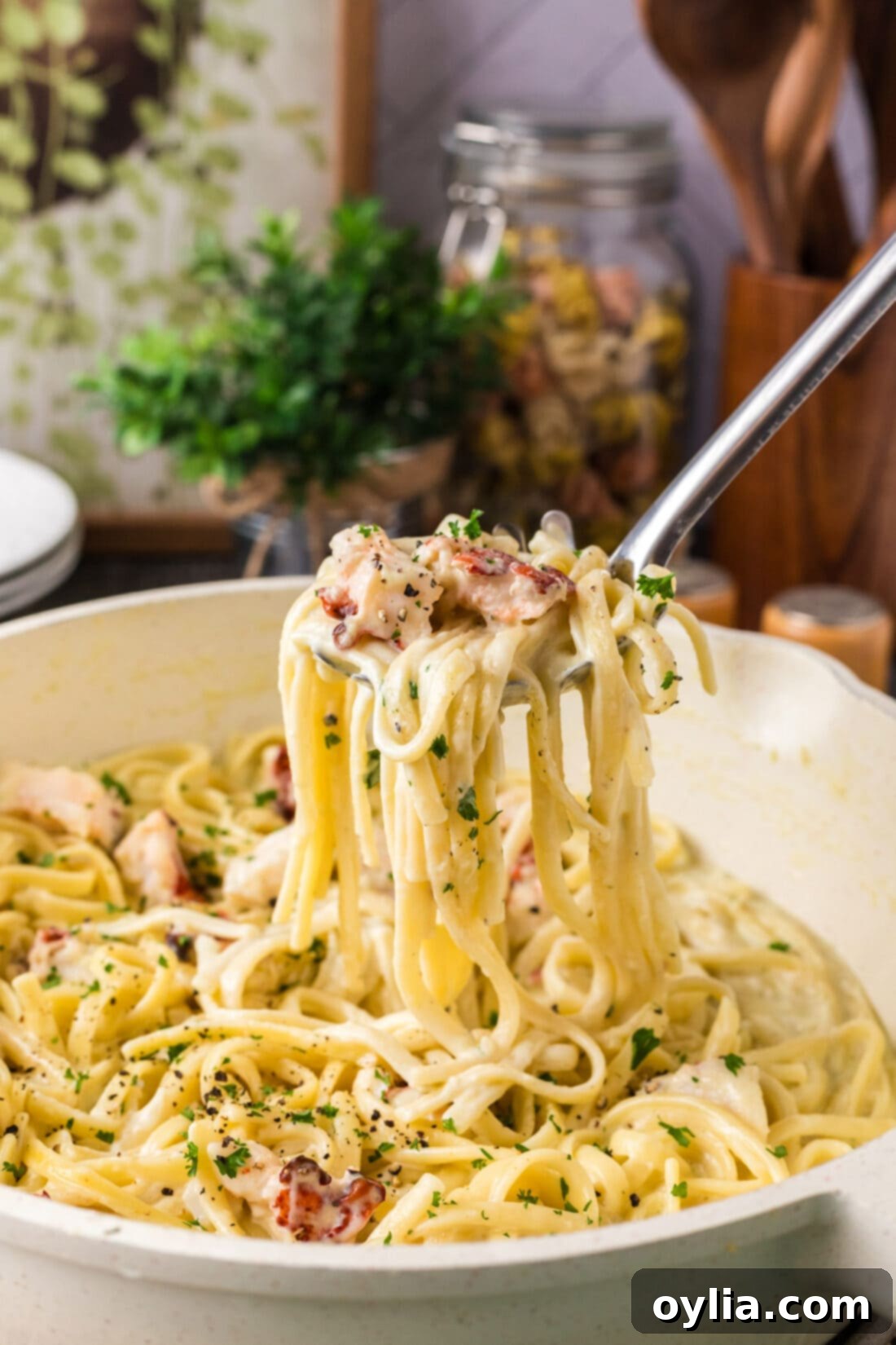 Decadent Lobster Pasta 2 Spoonful of Lobster Pasta being lifted out of a skillet