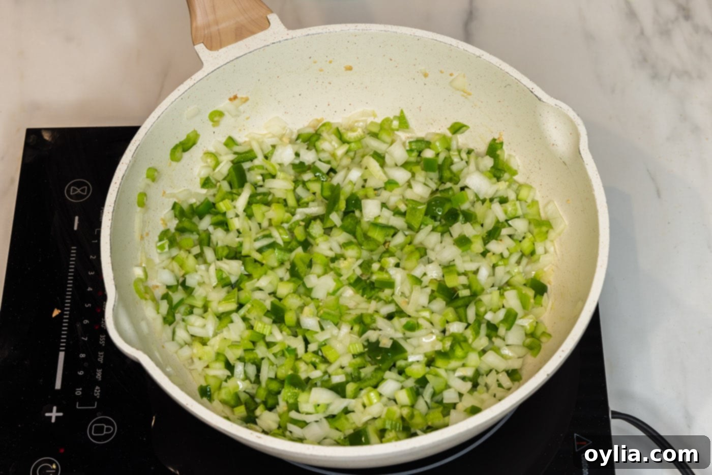 onion, bell pepper, celery, and garlic in a skillet