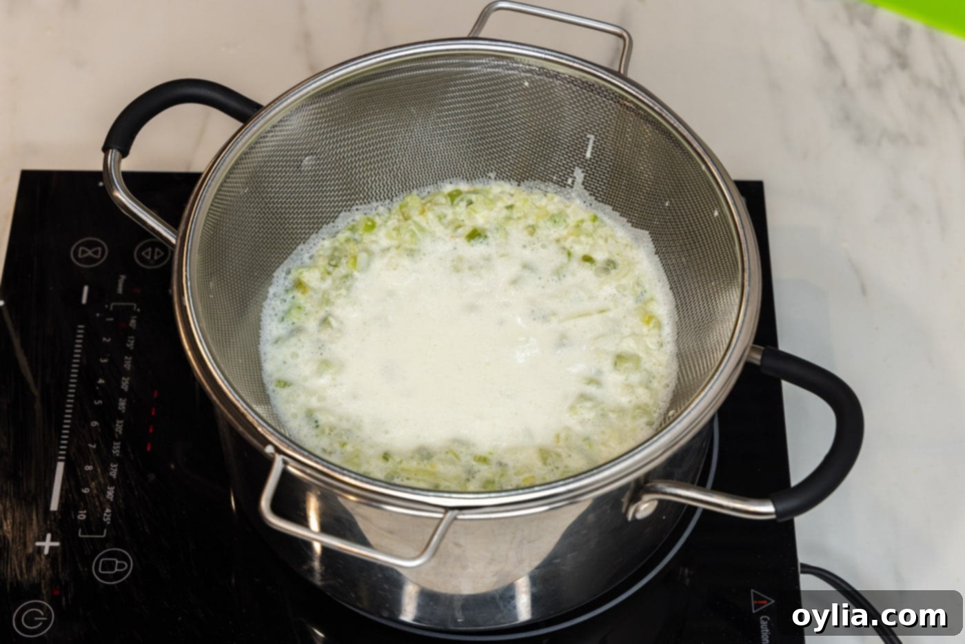 straining pasta sauce in a colander