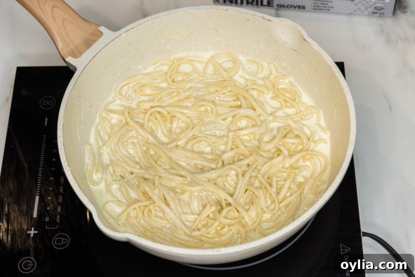 linguine noodles in skillet with lobster sauce