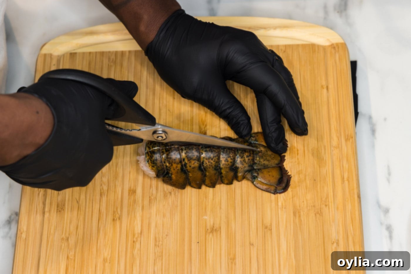 slicing lobster tail with kitchen shears