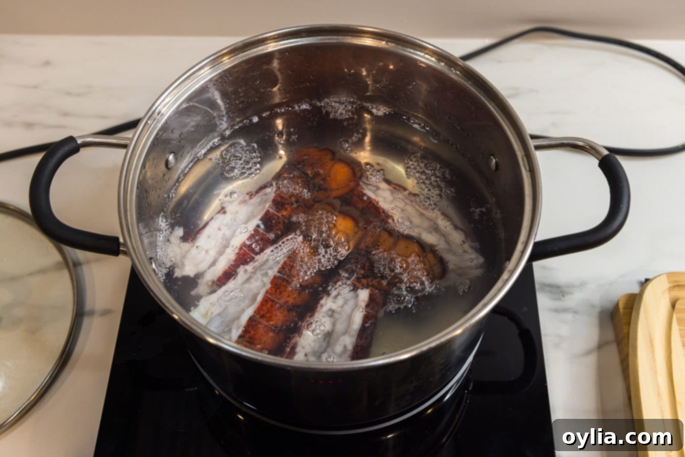 lobster tails cooking in a stockpot