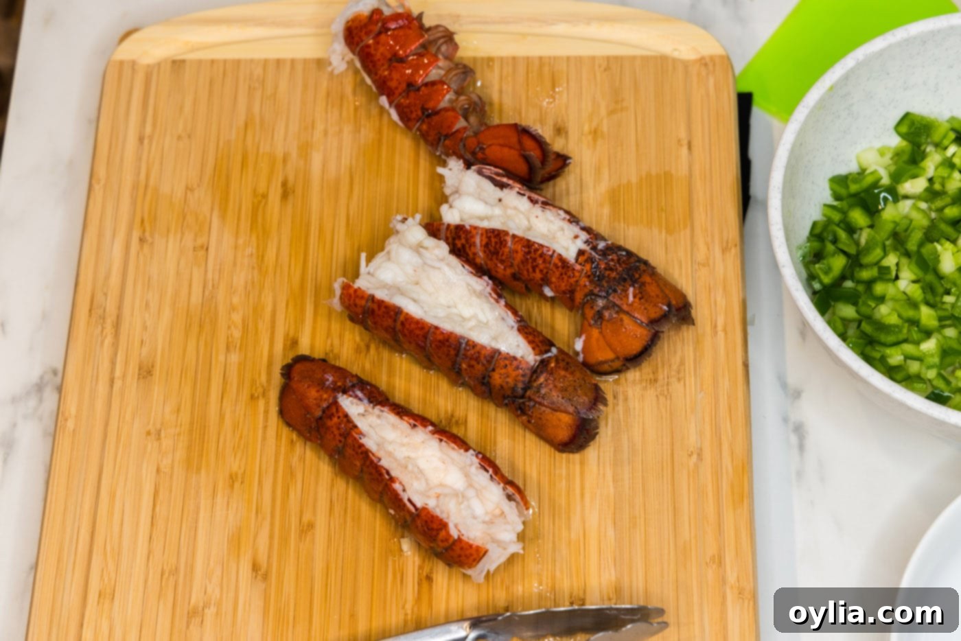 cooked lobster tails on a cutting board