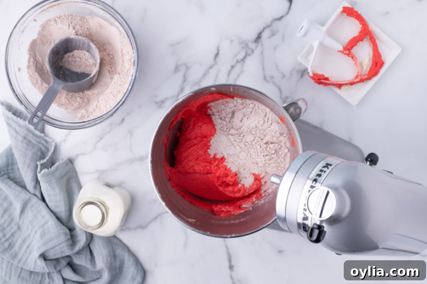 Mixing the dry ingredients for red velvet cupcakes into the wet batter