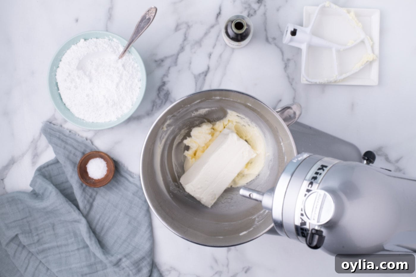 Beating cream cheese with butter in a mixer bowl until smooth and combined