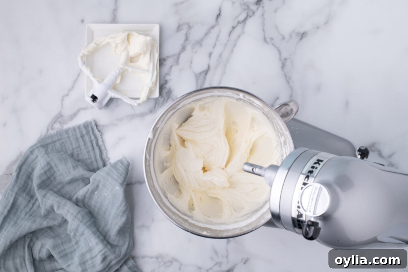 Smooth and creamy homemade cream cheese frosting in a mixer bowl