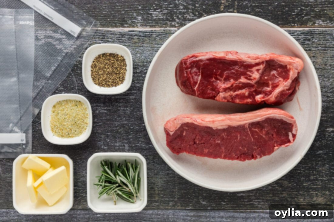 A selection of fresh ingredients laid out: New York strip steaks, fresh rosemary sprigs, butter, garlic salt, and black pepper, ready for sous vide preparation.