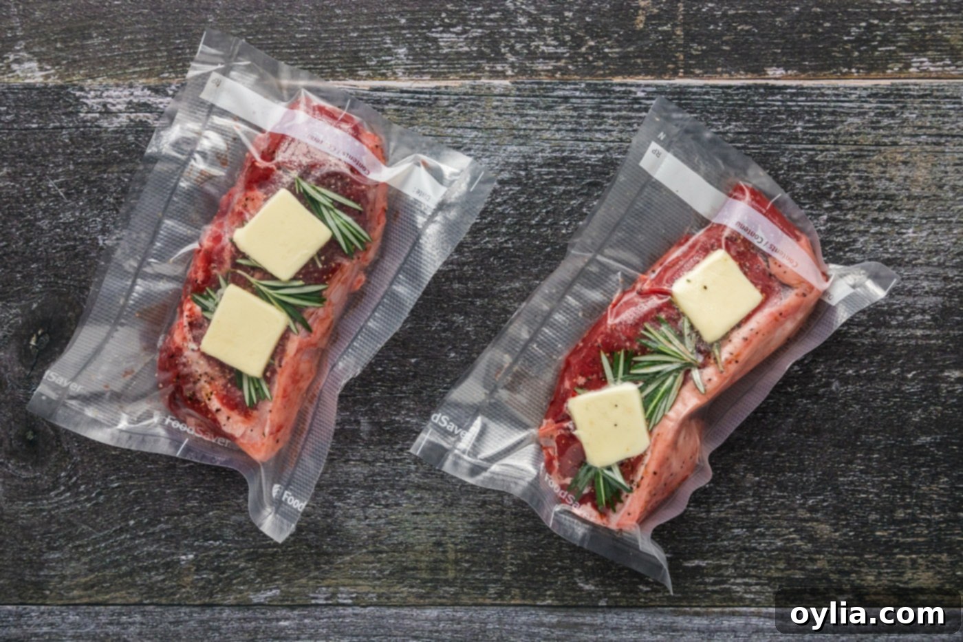 Two New York strip steaks, seasoned with rosemary and butter, individually vacuum sealed in bags.