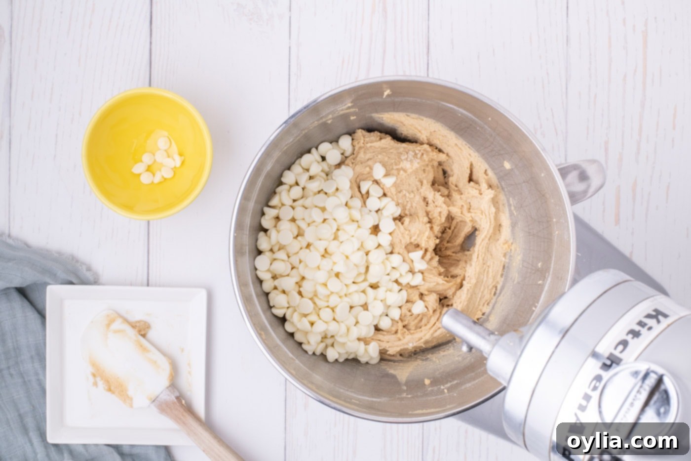 white chocolate chips in bowl of browned butter blondie batter
