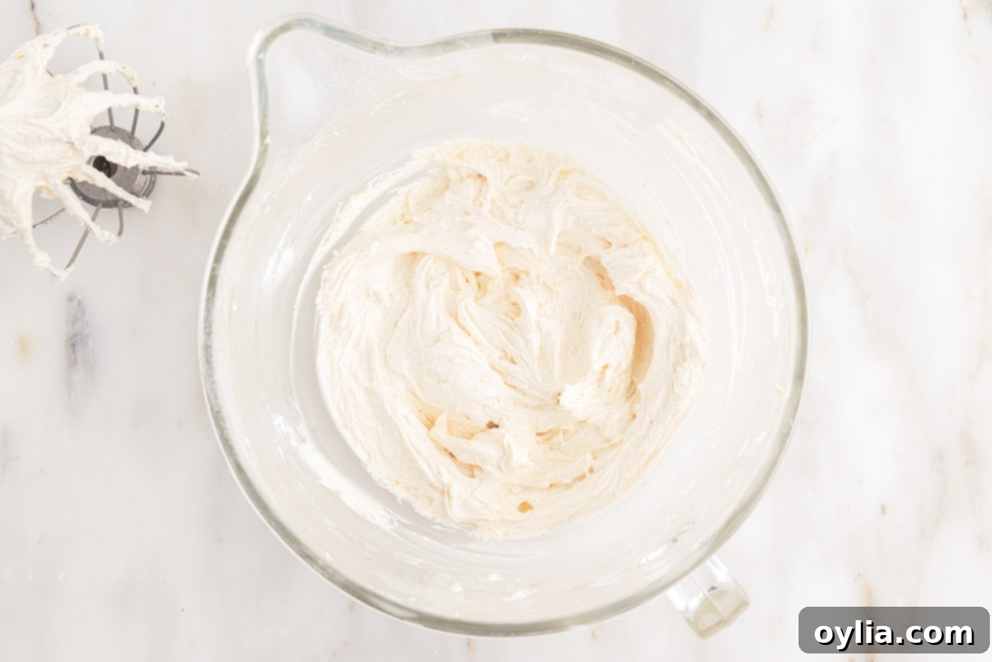 Creamy brown butter frosting after all ingredients are combined, ready for whipping to desired consistency.