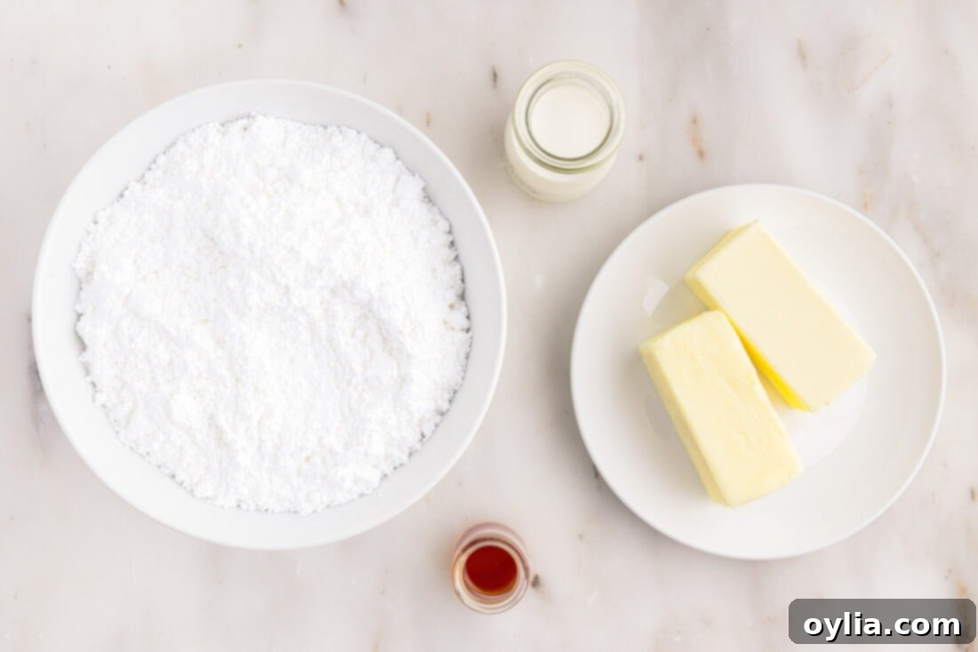 A flat lay of the four simple ingredients needed to make brown butter frosting: butter, powdered sugar, vanilla extract, and heavy cream.