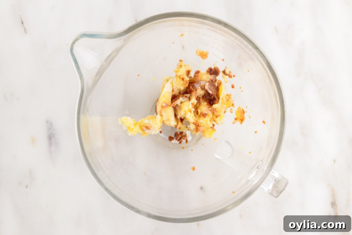 Cooled, solidified brown butter in the bowl of a stand mixer, ready for whipping.