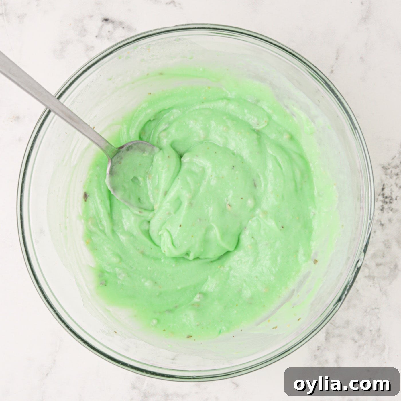 Instant pistachio pudding mix being prepared in a bowl.