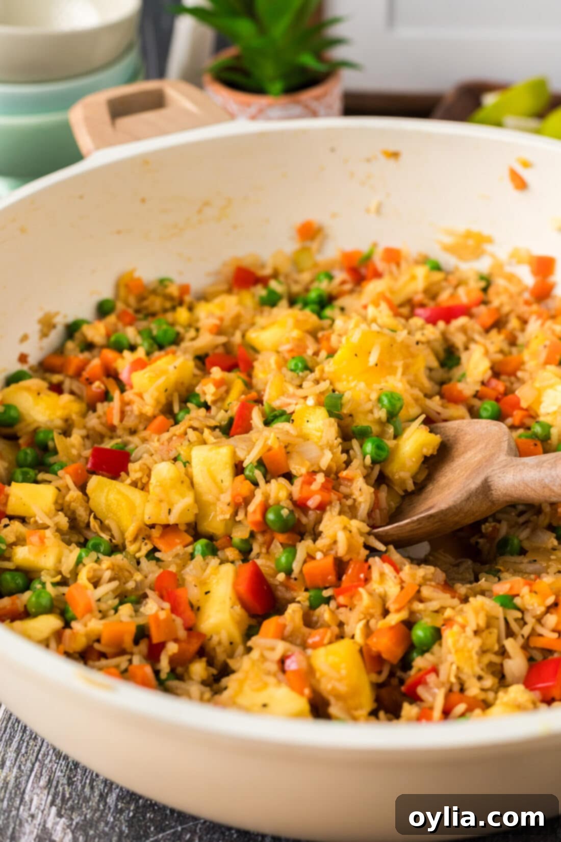 Close up photo of Pineapple Fried Rice in a skillet with a spoon