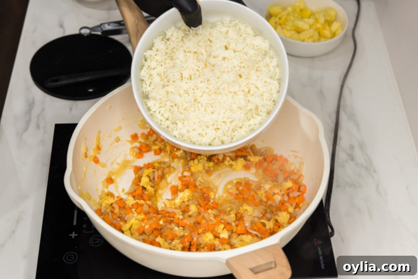 cooked rice added to pan of stir fried veggies and egg