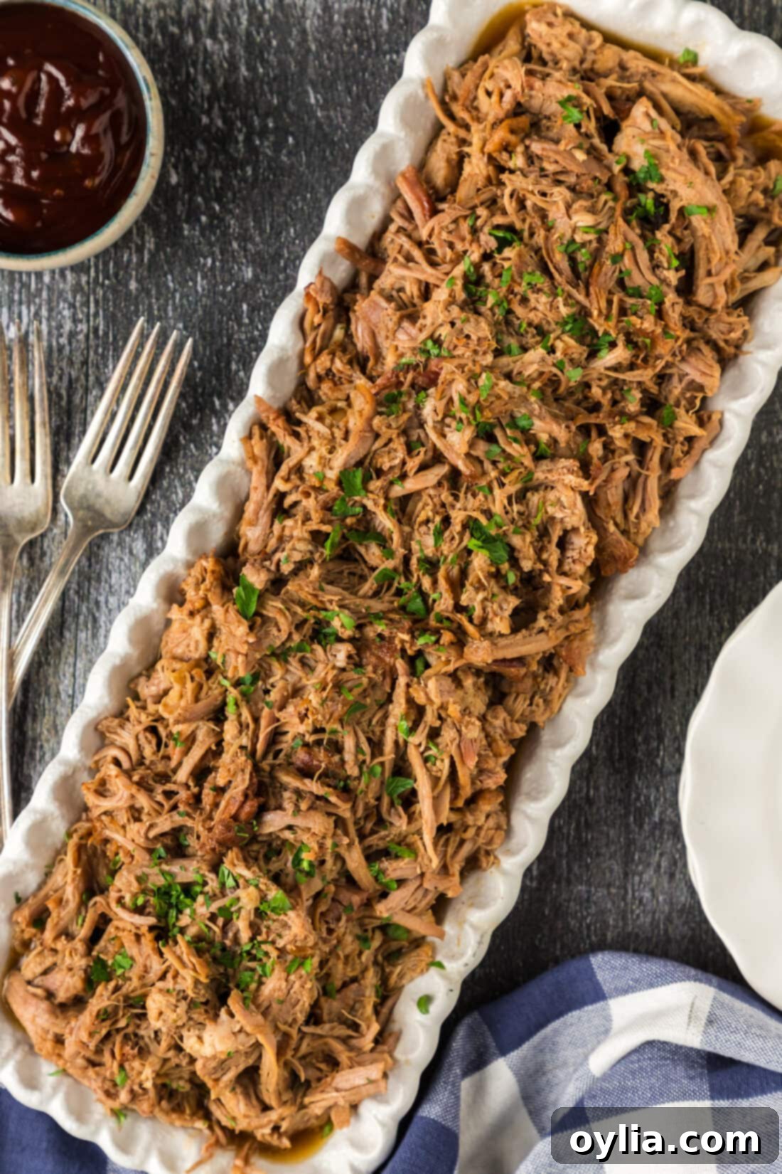 Pulled Pork Perfection 2 A generous platter of perfectly shredded, dark, and tender pulled pork, ready to be served, showcasing its juicy texture and rich color.