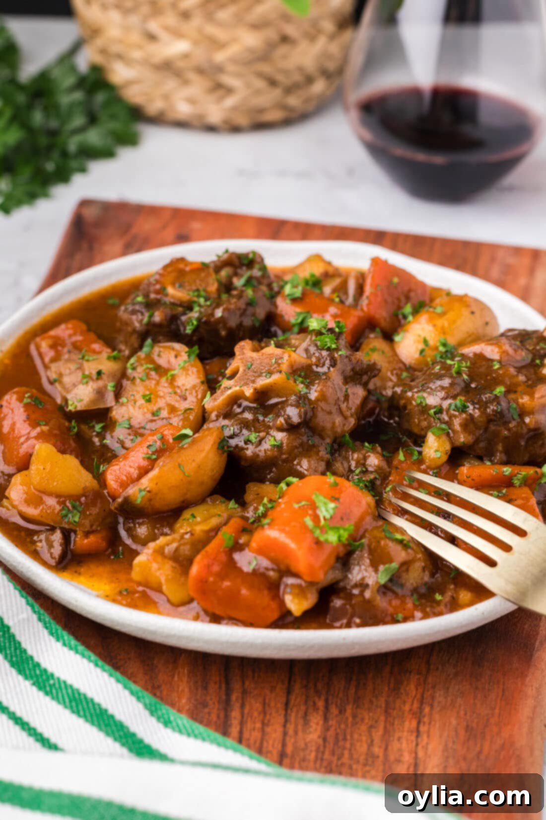 Close up photo of a plate of Instant Pot Oxtail with a fork on it