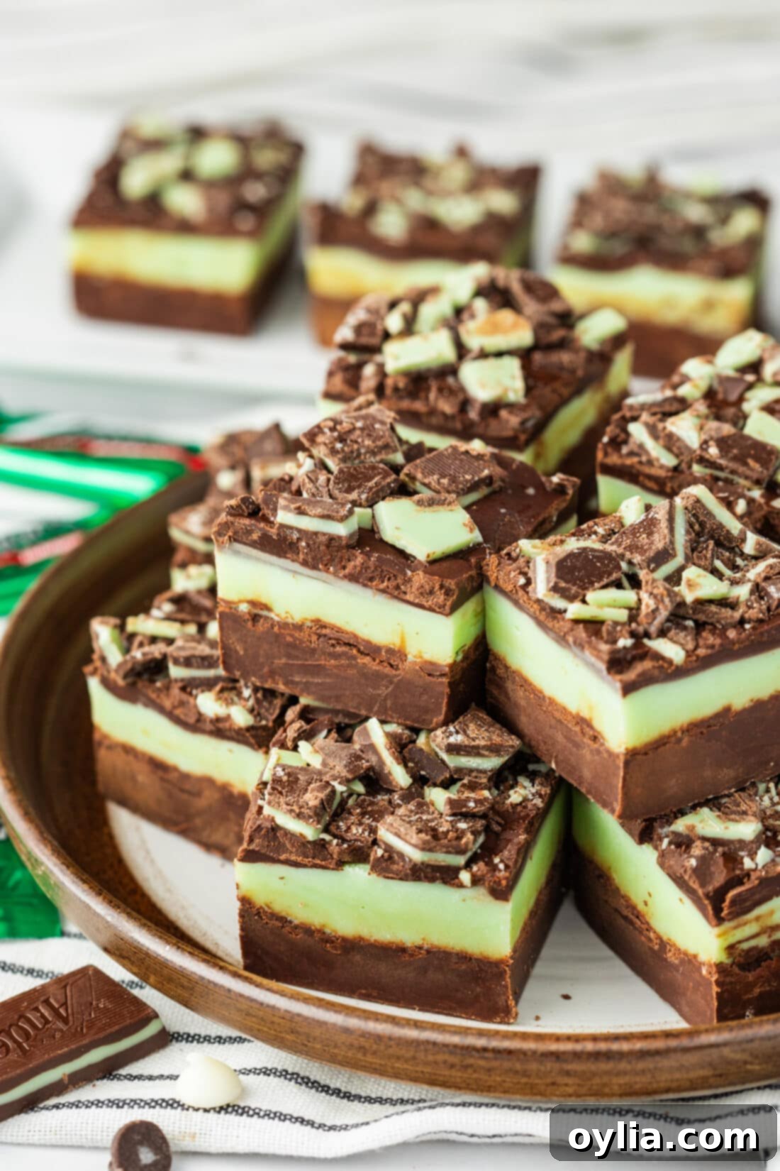 Andes Mint Chocolate Fudge 13 Delicious Andes Mint Fudge squares stacked neatly on a white plate, ready to be served