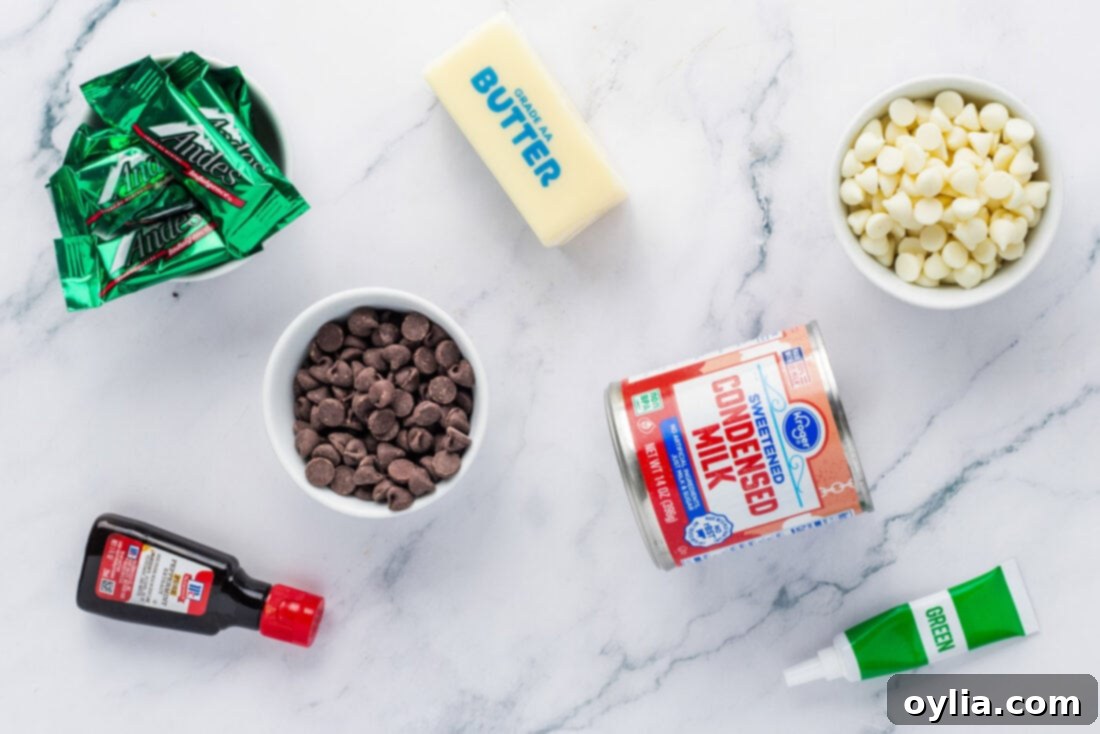 Andes Mint Chocolate Fudge 4 Various ingredients for Andes Mint Fudge, including chocolate chips, sweetened condensed milk, butter, and Andes mints, laid out on a clean surface