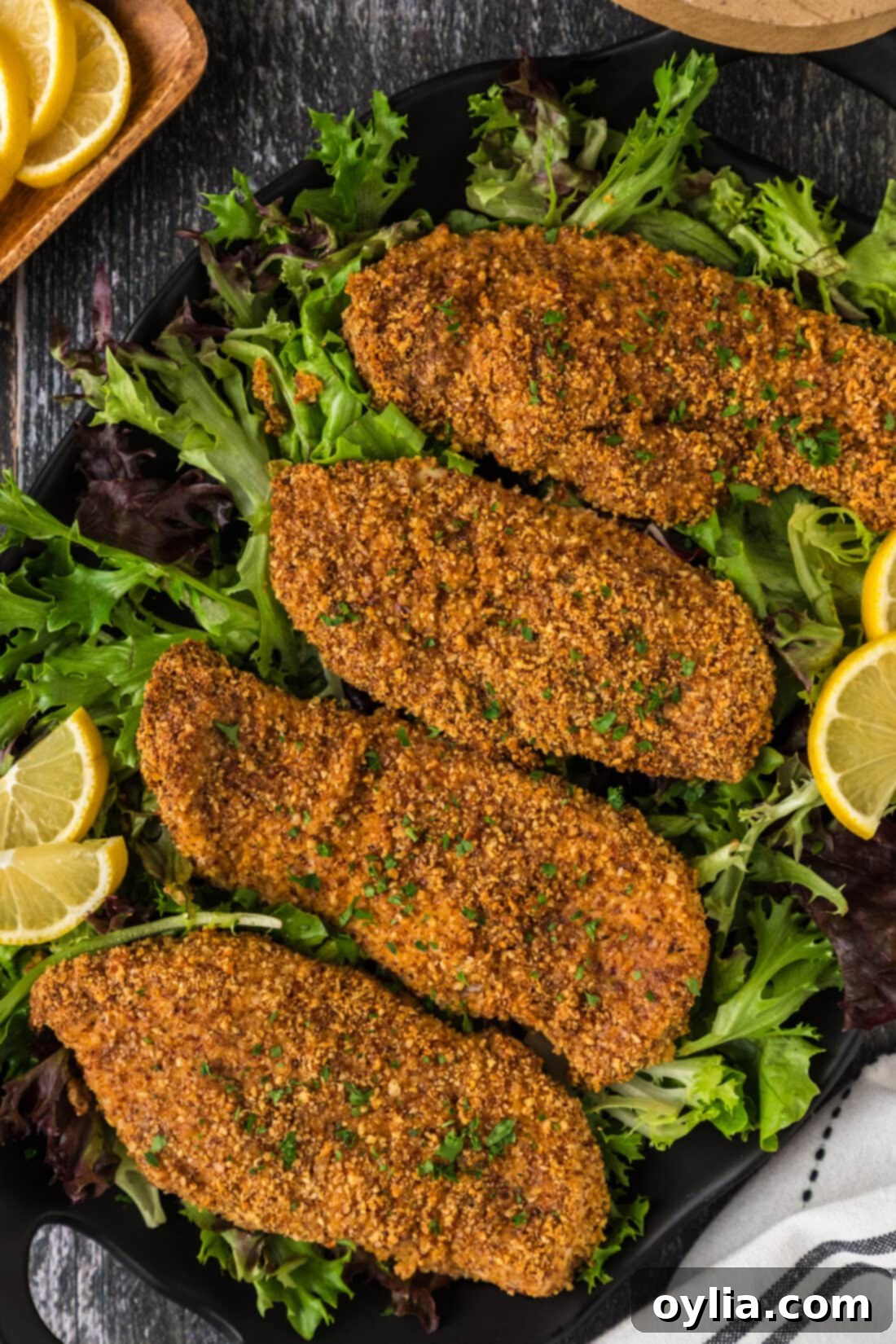 Four Almond Crusted Chicken breasts on a platter