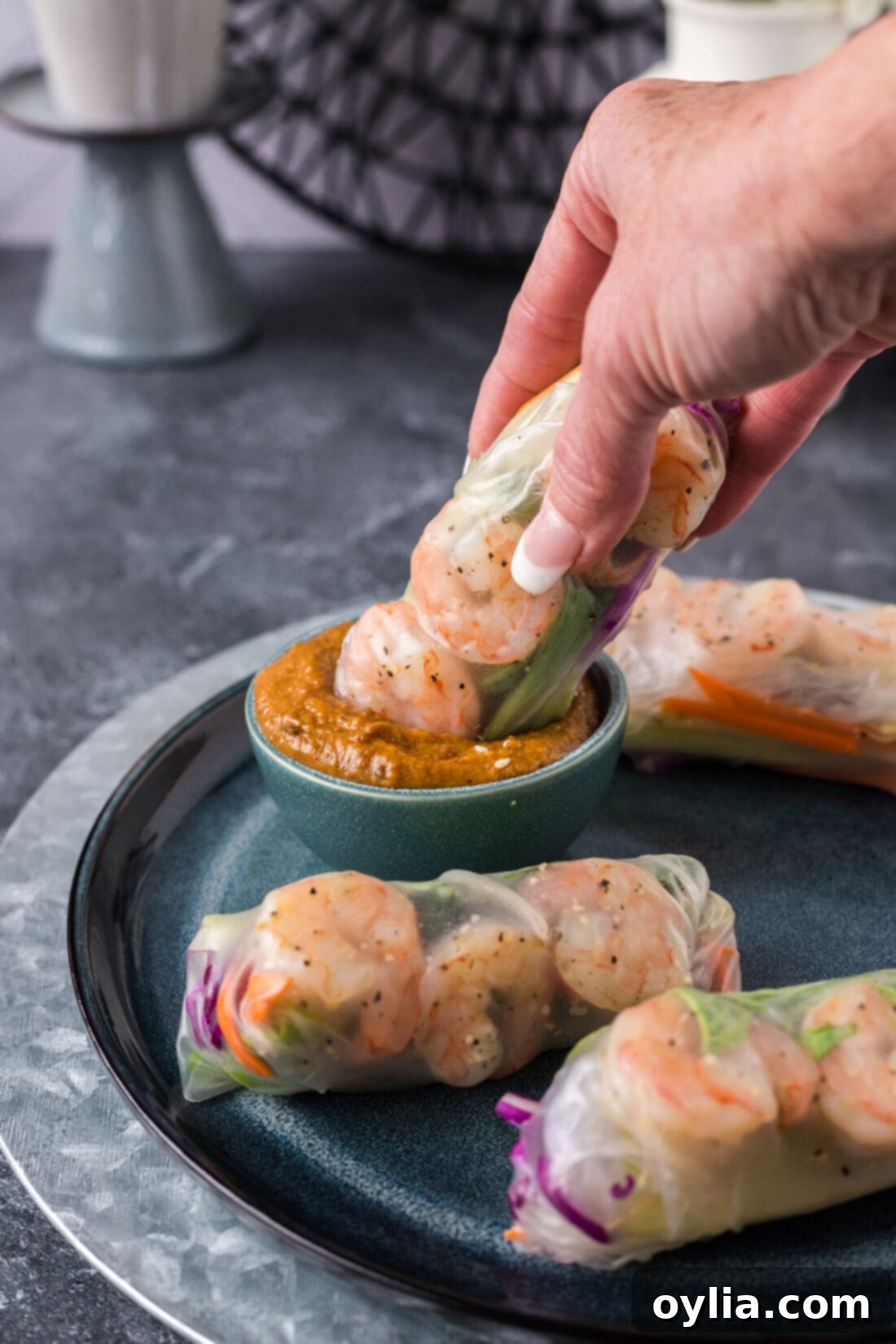 Shrimp Spring Roll being dipped into a a bowl of delicious sauce, highlighting its freshness