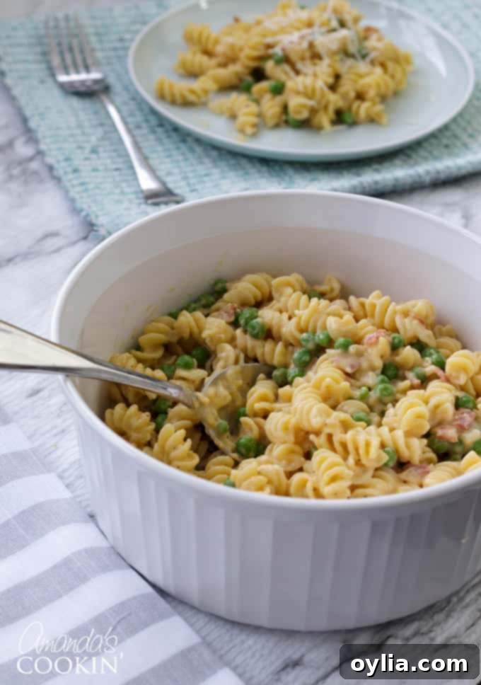 bowl of rotini with peas and cheese, showcasing the creamy texture